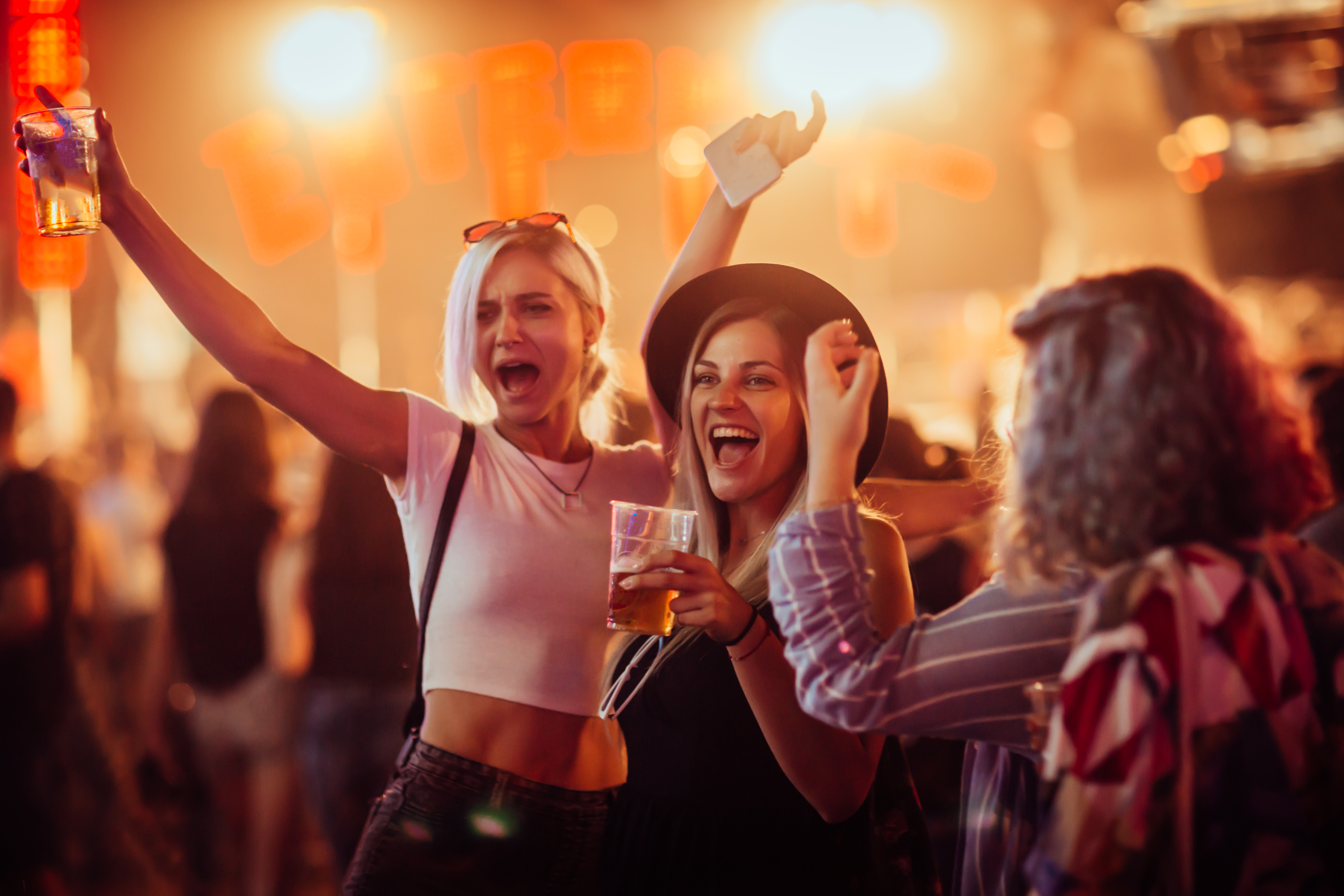 Friends cheering at a festival