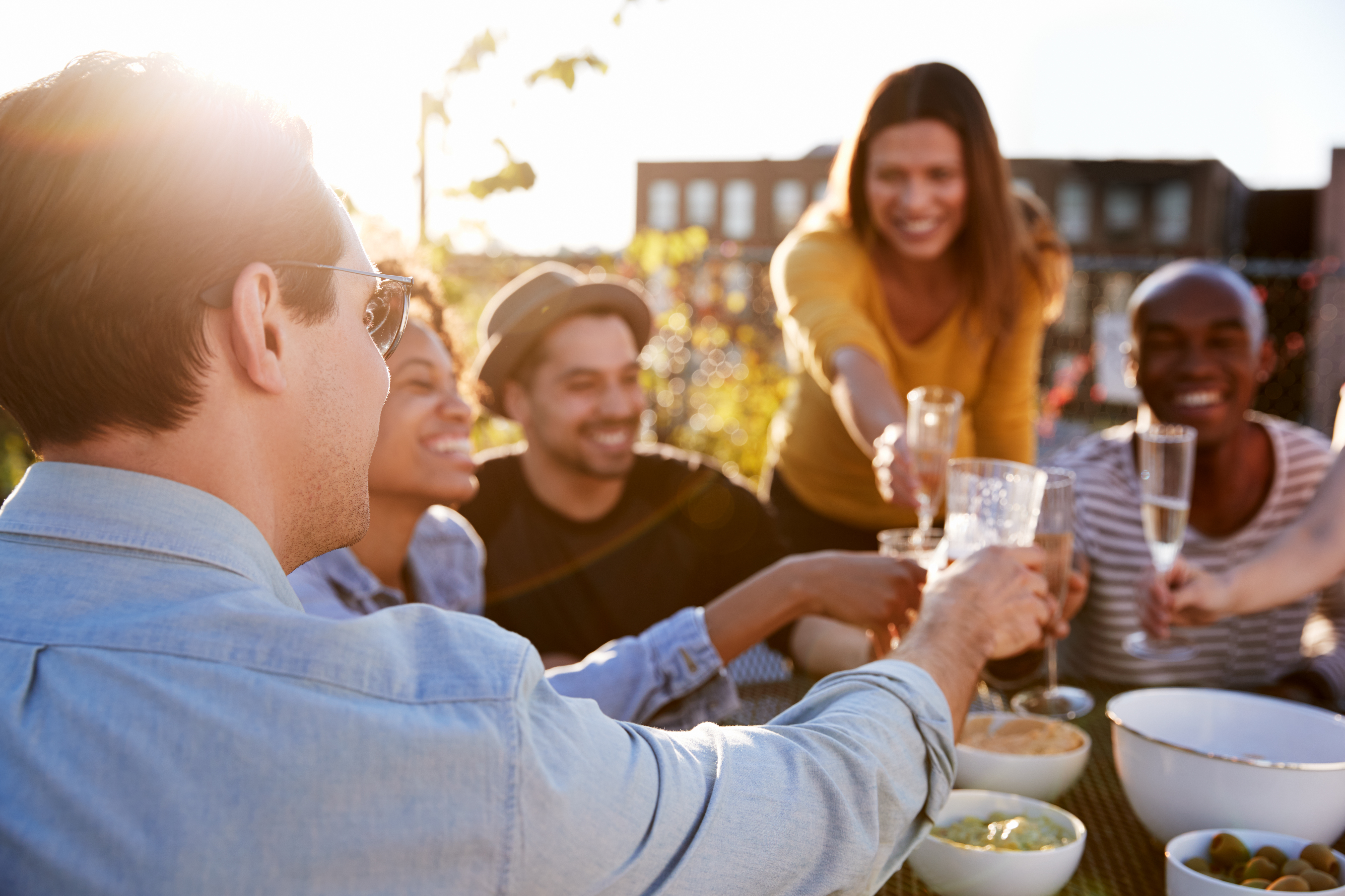 Friends toasting on a rooftop